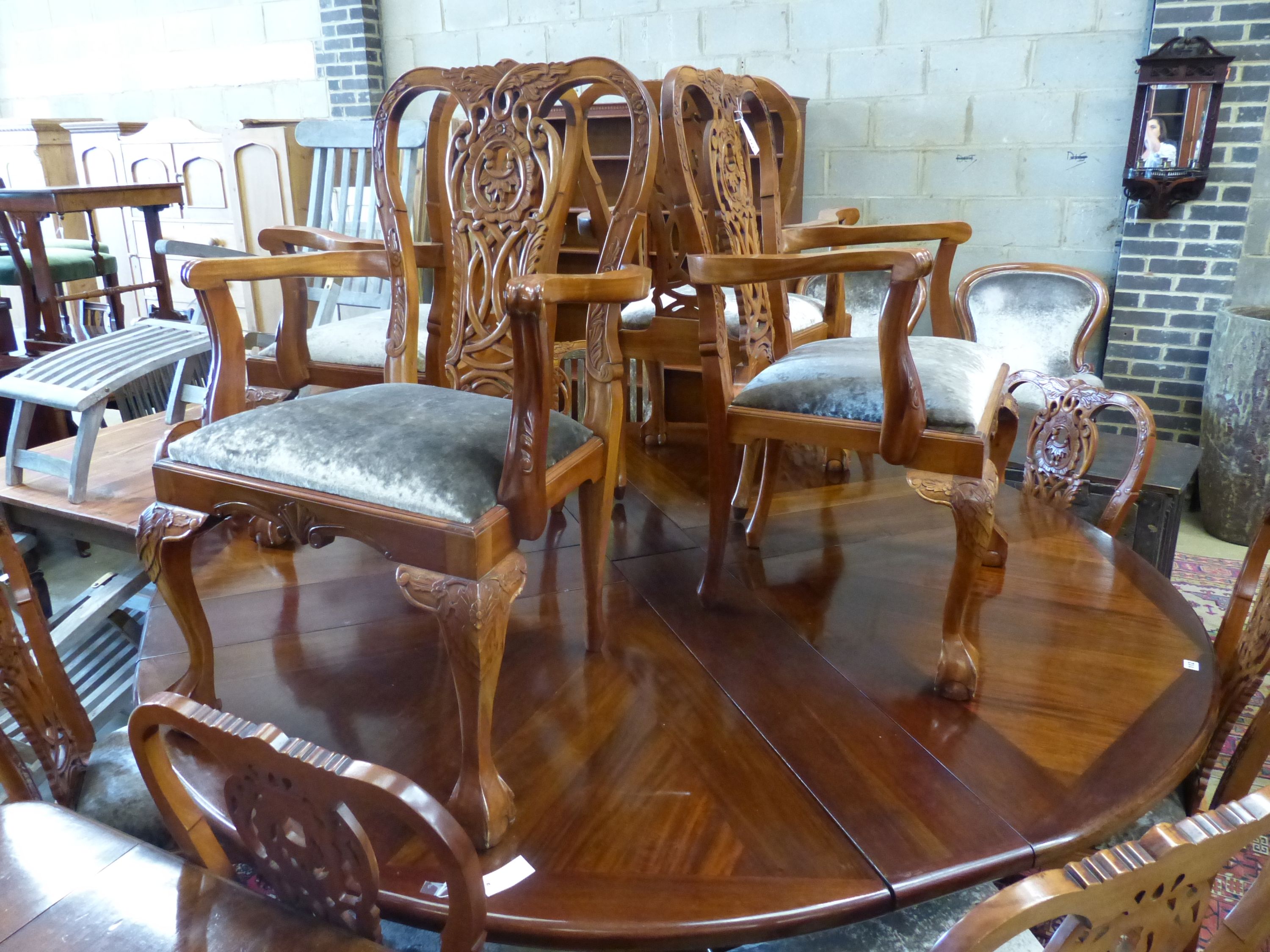 A set of twelve Chippendale style mahogany dining chairs, four with arms